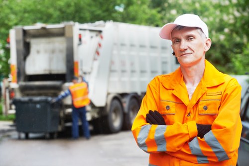 Construction site with debris being collected by waste removal service