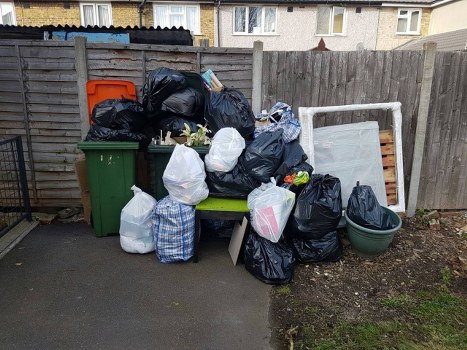 Rubbish removal team loading waste into truck