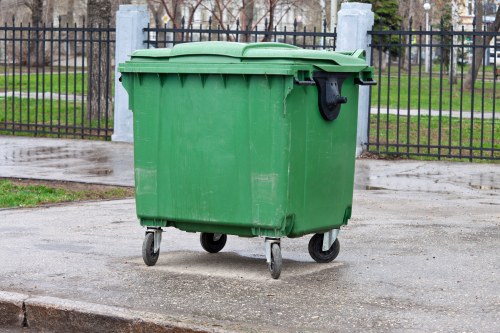Domestic skip being loaded with household waste