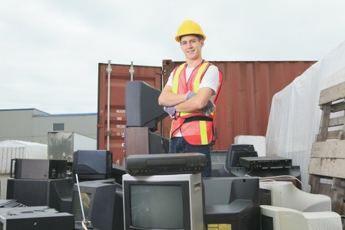 Worker placing cones and signage around a skip for public protection